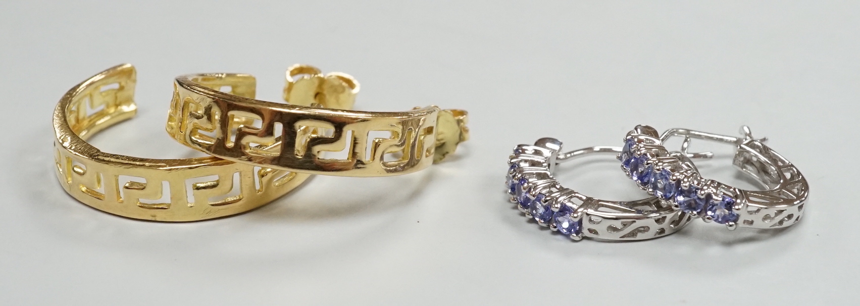 A modern pair of Middle Eastern? pierced yellow metal half hoop earrings, 23mm 6.7 grams and a modern pair of 14k white metal and gem set half hoop earrings, gross 2.5 grams.